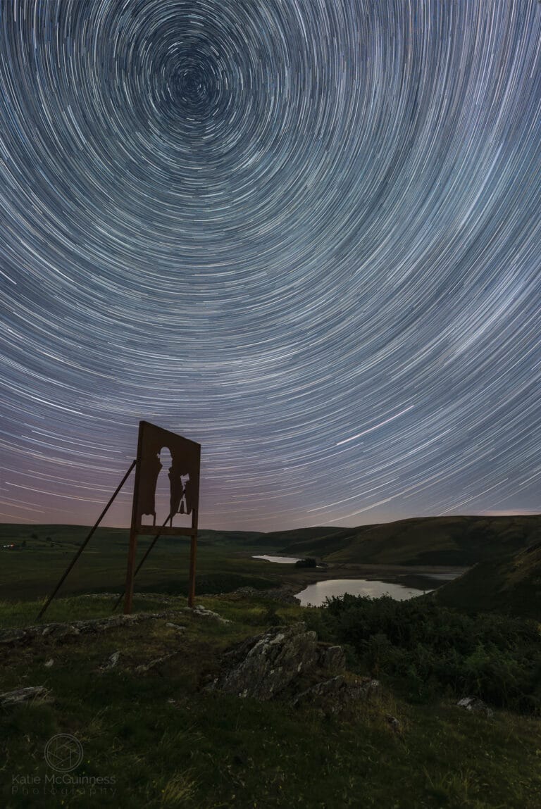 Star trails and faint aurora at the Alyn Wallace Memorial artwork overlooking Craig Goch Dam in the Elan Valley